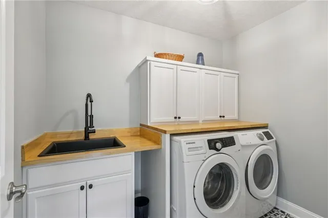 a view of a sink and washer dryer