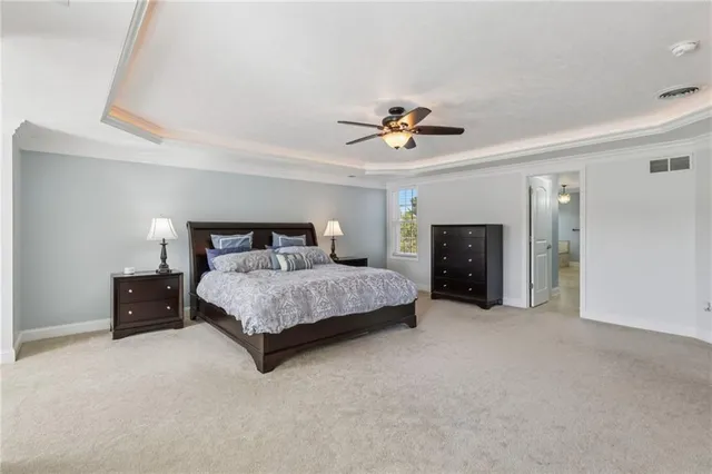 a spacious bedroom with a bed and a fireplace