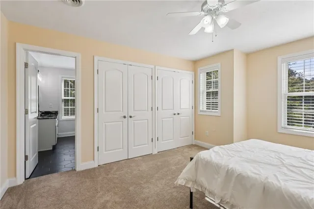 a kitchen with a refrigerator and white cabinets