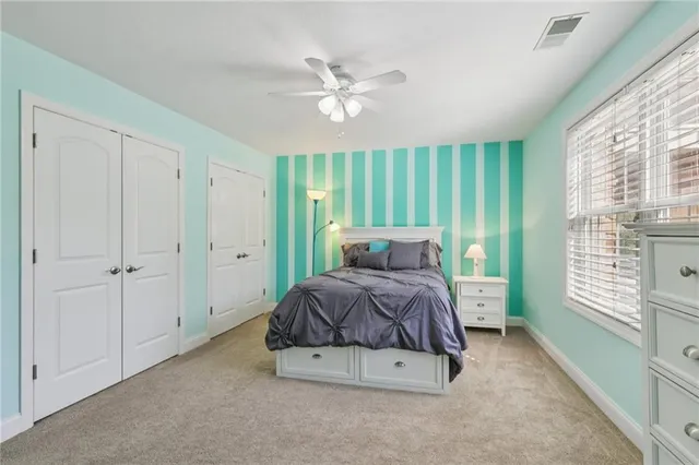 a bedroom with a bed and a large window