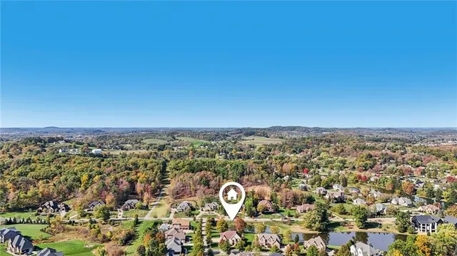 an aerial view of residential house with outdoor space and swimming pool