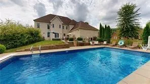 a aerial view of a house with table and chairs under an umbrella