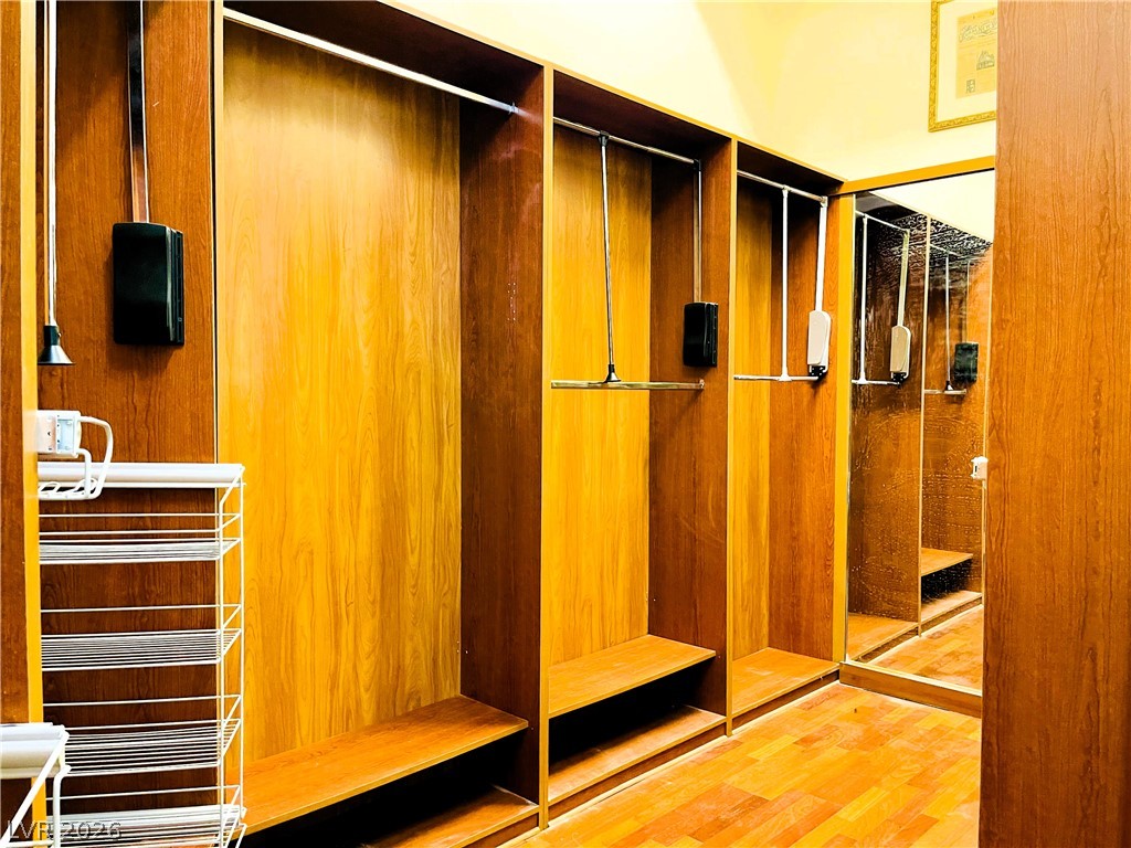 360 East Desert Inn Road, Unit 507 Las Vegas, NV 89109 - Photo 16 of 37 Rich wood built-ins and custom shelving maximize storage in this spacious walk-in closet.