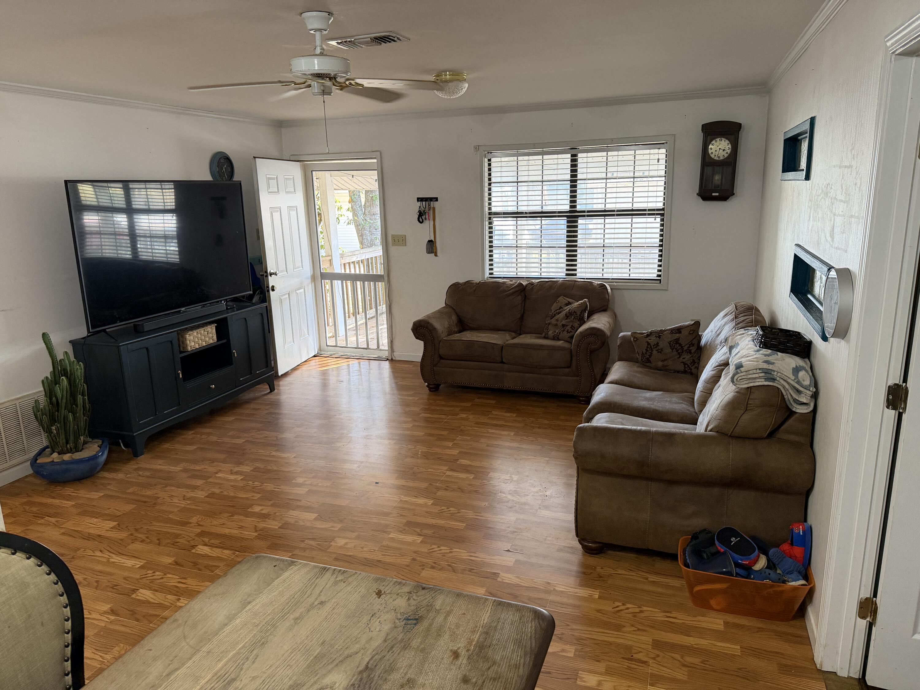 5875 Oak Hill Road Crestview, FL 32536 - Photo 12 of 43 a living room with furniture window and a flat screen tv
