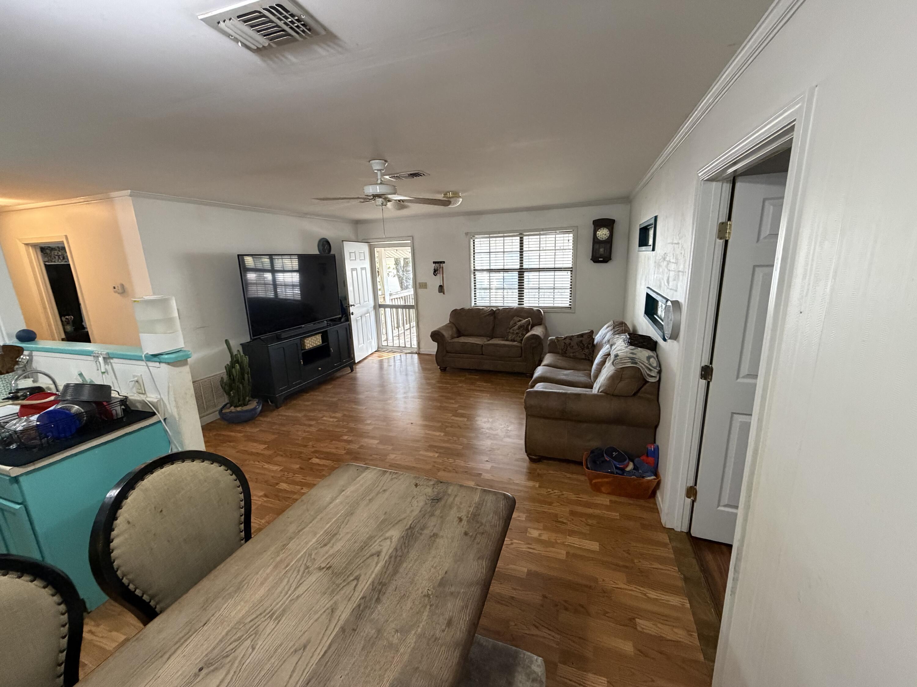 5875 Oak Hill Road Crestview, FL 32536 - Photo 13 of 43 a living room with furniture and a flat screen tv