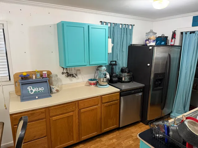 a kitchen with stainless steel appliances a stove and a refrigerator