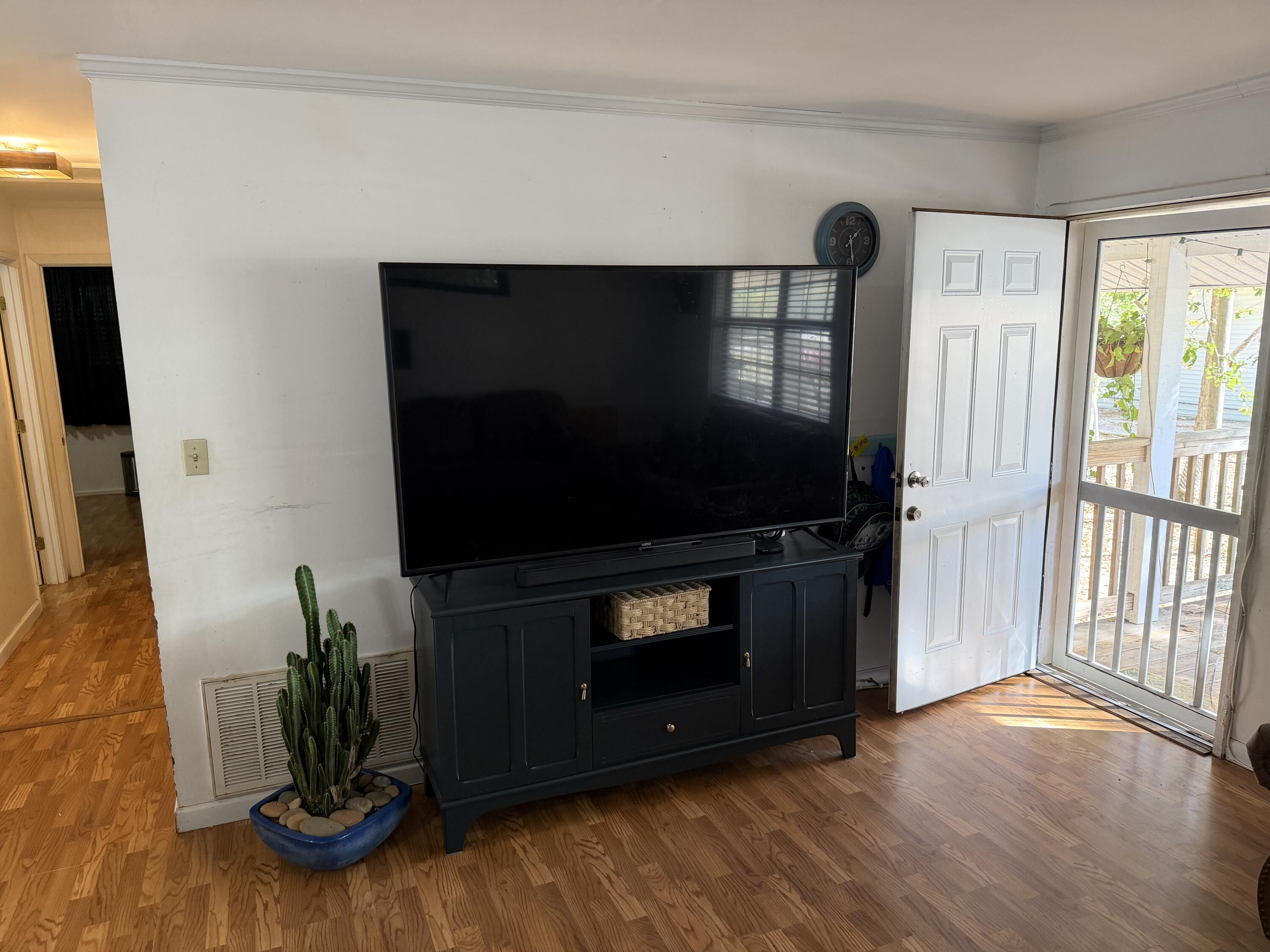 5875 Oak Hill Road Crestview, FL 32536 - Photo 18 of 43 a living room with furniture and a flat screen tv