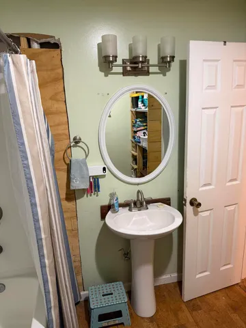 a bathroom with a shower a toilet and a tub