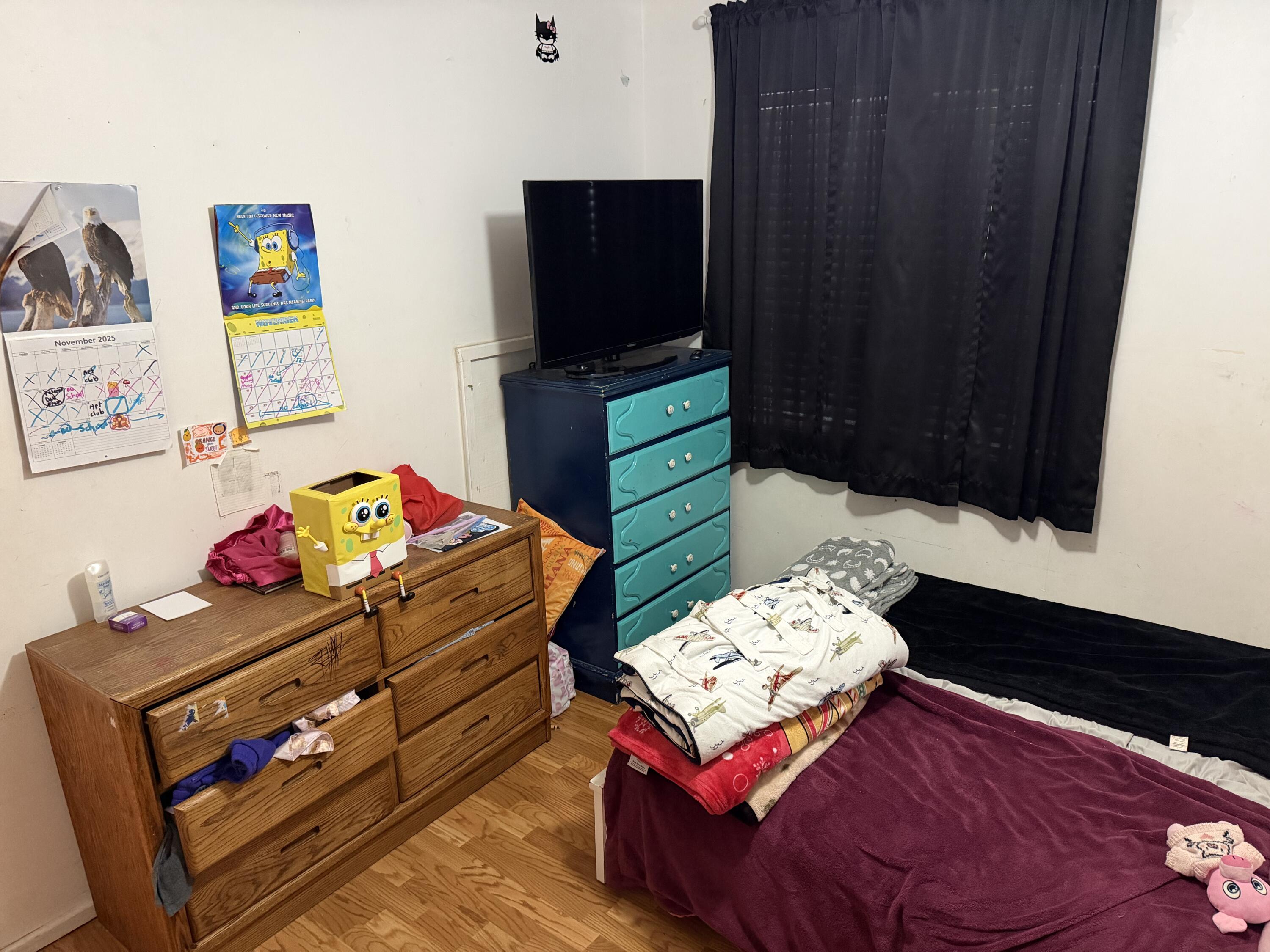 5875 Oak Hill Road Crestview, FL 32536 - Photo 27 of 43 a bedroom with a bed and wooden floor