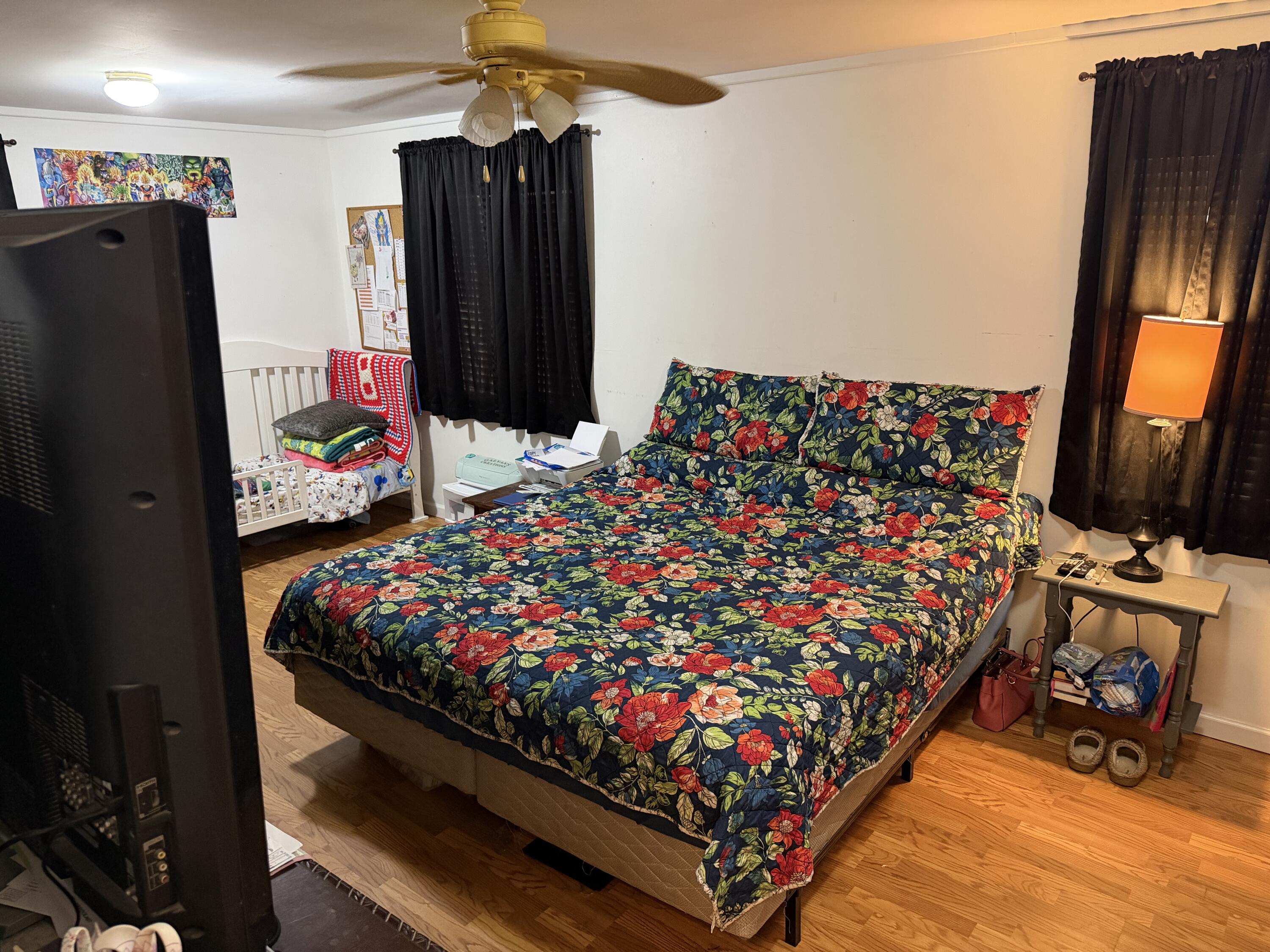 5875 Oak Hill Road Crestview, FL 32536 - Photo 29 of 43 a bed room with a large bed and a flat tv screen