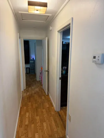 a room with painting on the wall and a potted plant