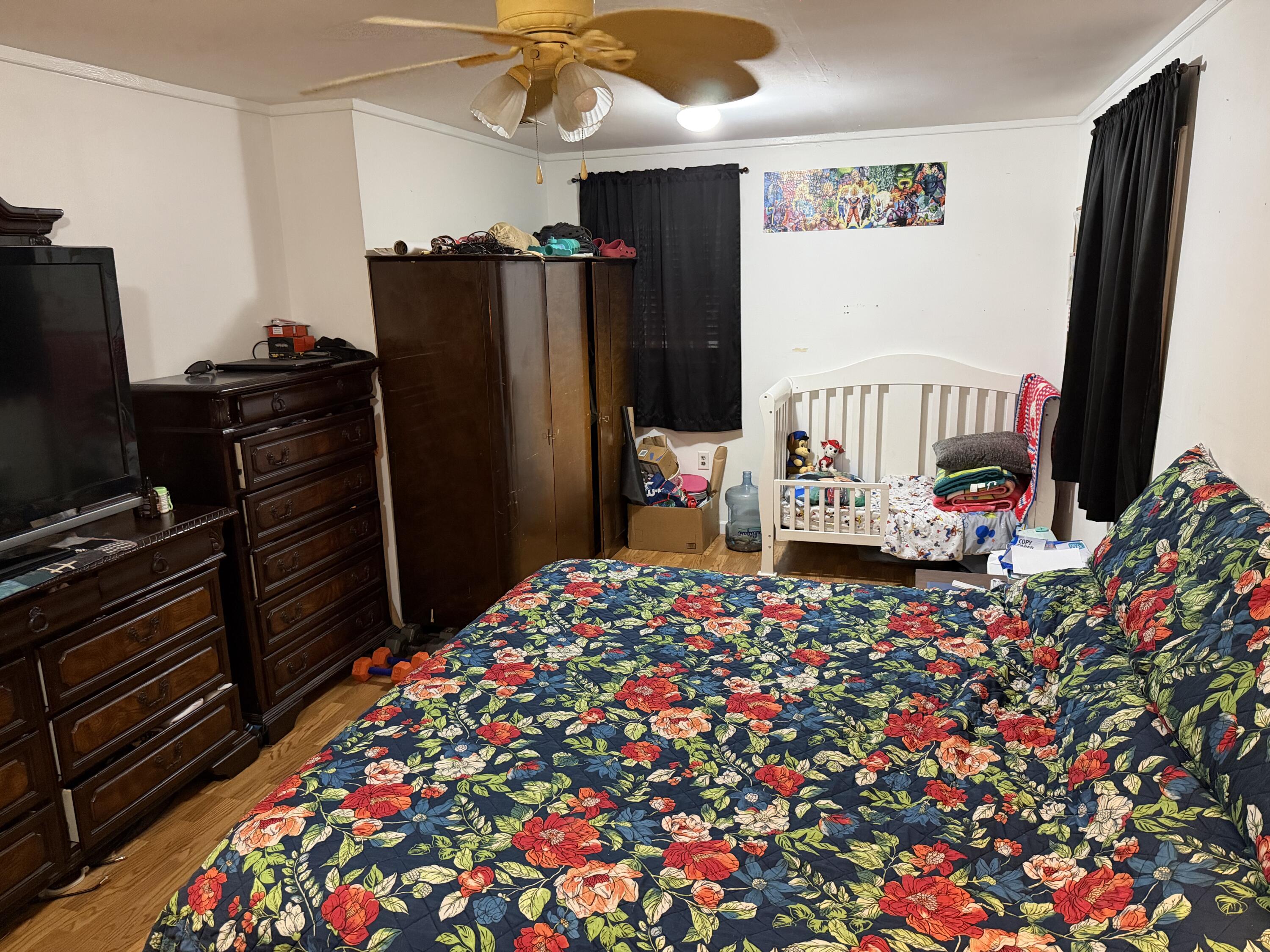 5875 Oak Hill Road Crestview, FL 32536 - Photo 34 of 43 a bedroom with a bed and a flat screen tv