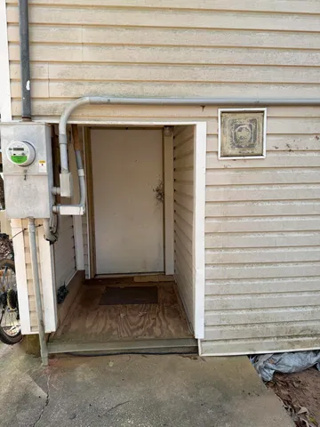 a room with a storage refrigerator and a flat screen tv