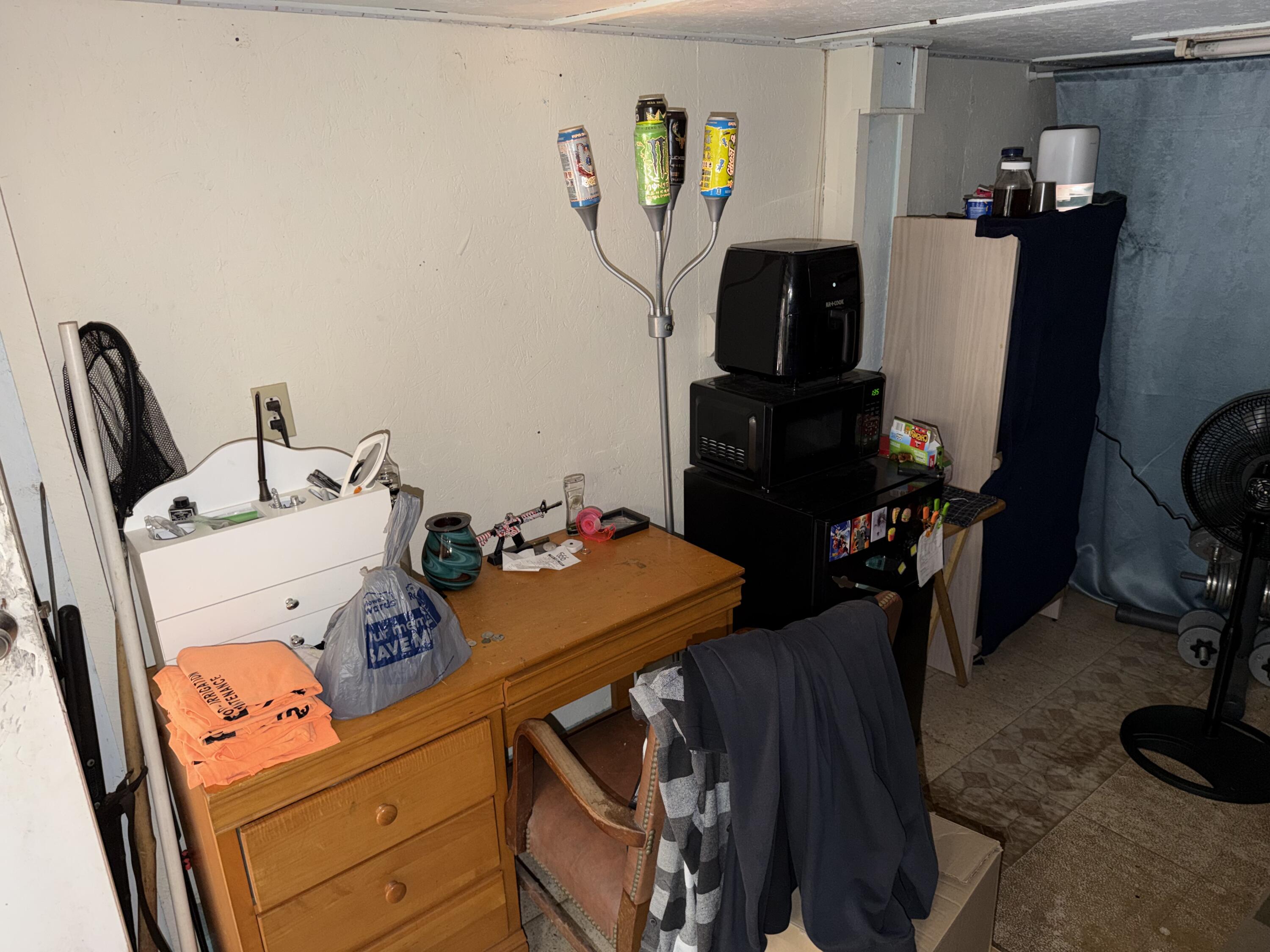 5875 Oak Hill Road Crestview, FL 32536 - Photo 37 of 43 a room with a storage refrigerator and a flat screen tv