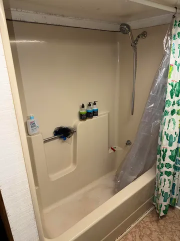 a bedroom with a bed closet and mirror