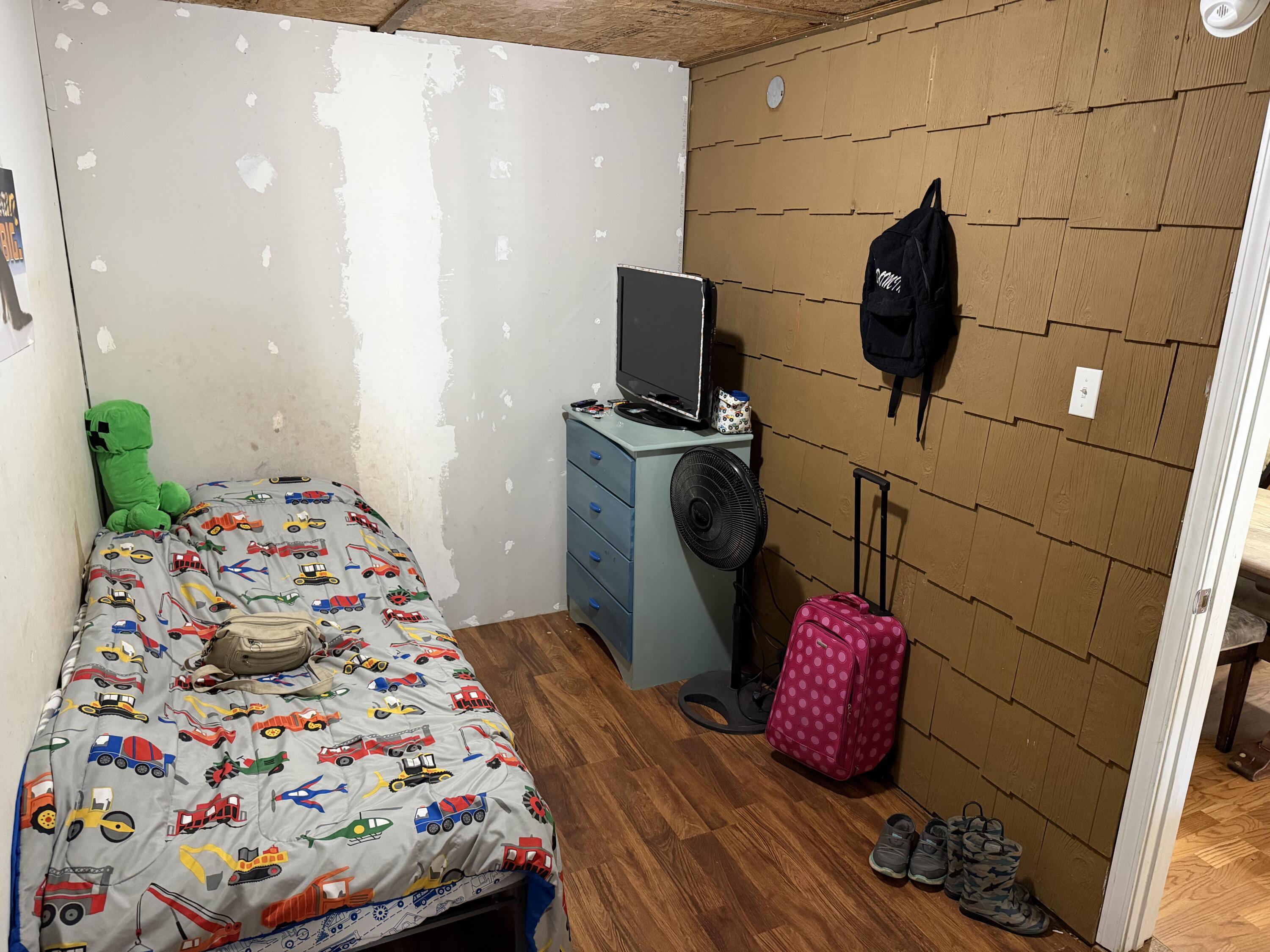 5875 Oak Hill Road Crestview, FL 32536 - Photo 5 of 43 a bedroom with a bed and wooden floor