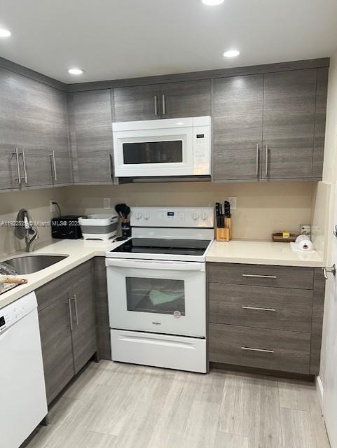 1865 79th Street Causeway, Unit 10C North Bay Village, FL 33141 - Photo 12 of 26 a kitchen with a sink stove and cabinets