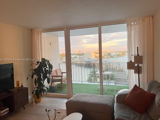 1865 79th Street Causeway, Unit 10C North Bay Village, FL 33141 - Photo 6 of 26 a living room with furniture and a flat screen tv