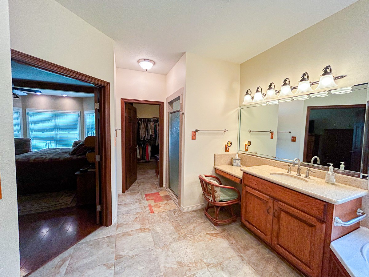 5259 Farm To Market 946 Coldspring, TX 77331 - Photo 14 of 39 a en suite bathroom with a double vanity sink and a mirror