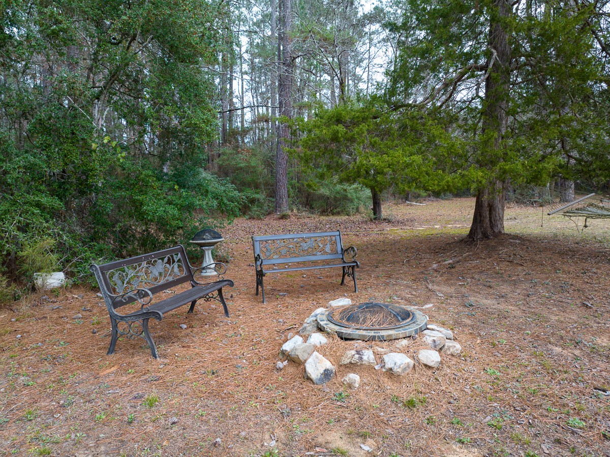 5259 Farm To Market 946 Coldspring, TX 77331 - Photo 26 of 39 a backyard of a house with table and chairs