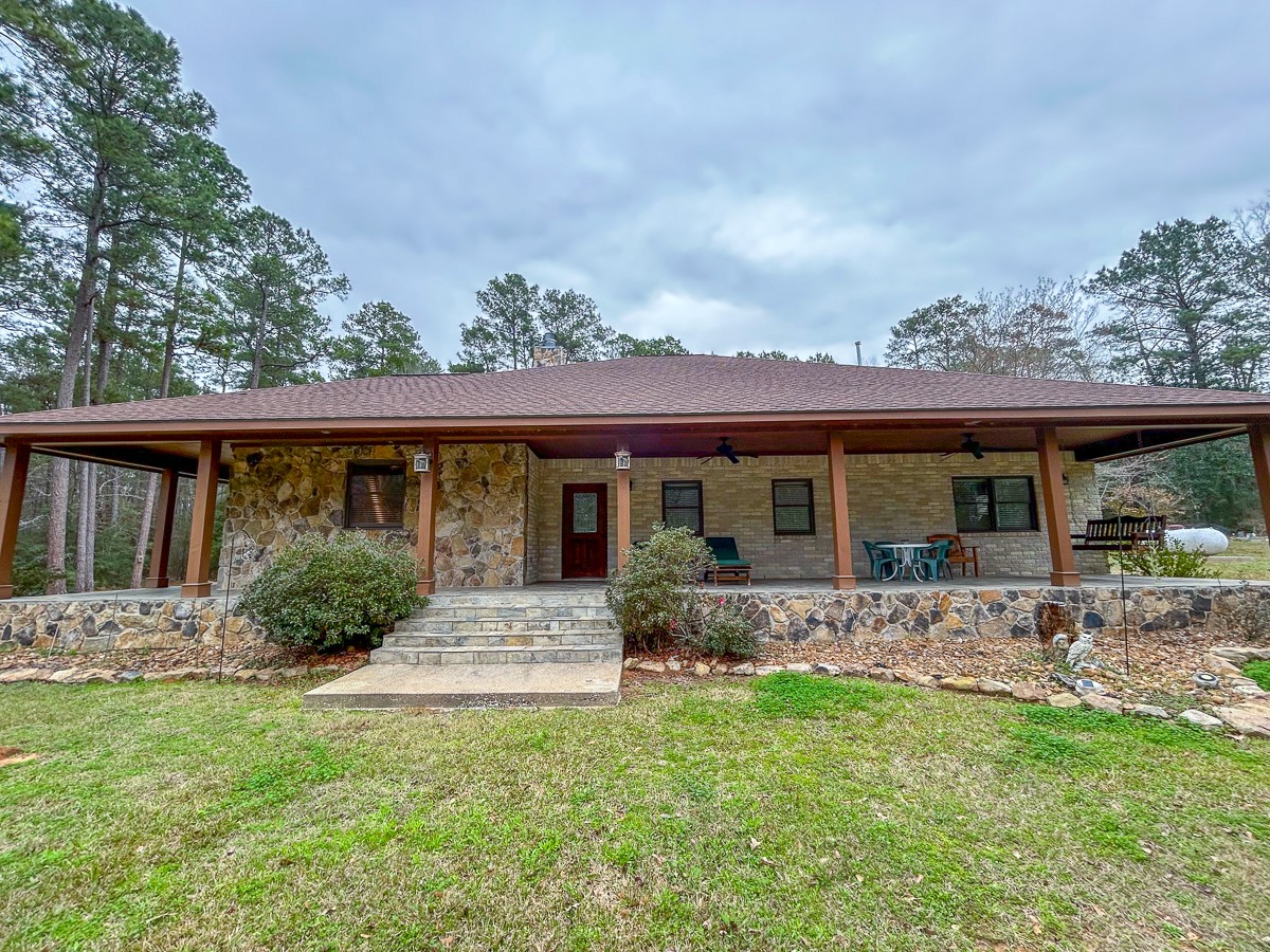 5259 Farm To Market 946 Coldspring, TX 77331 - Photo 3 of 39 a front view of house with yard porch and furniture