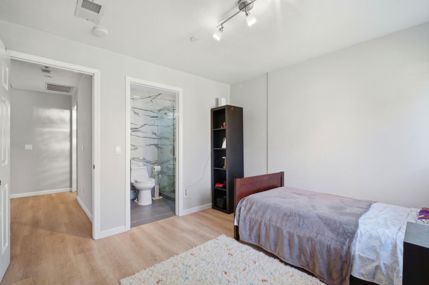 36985 Walnut Street Newark, CA 94560 - Photo 16 of 30 a bedroom with a bed and a walk in closet
