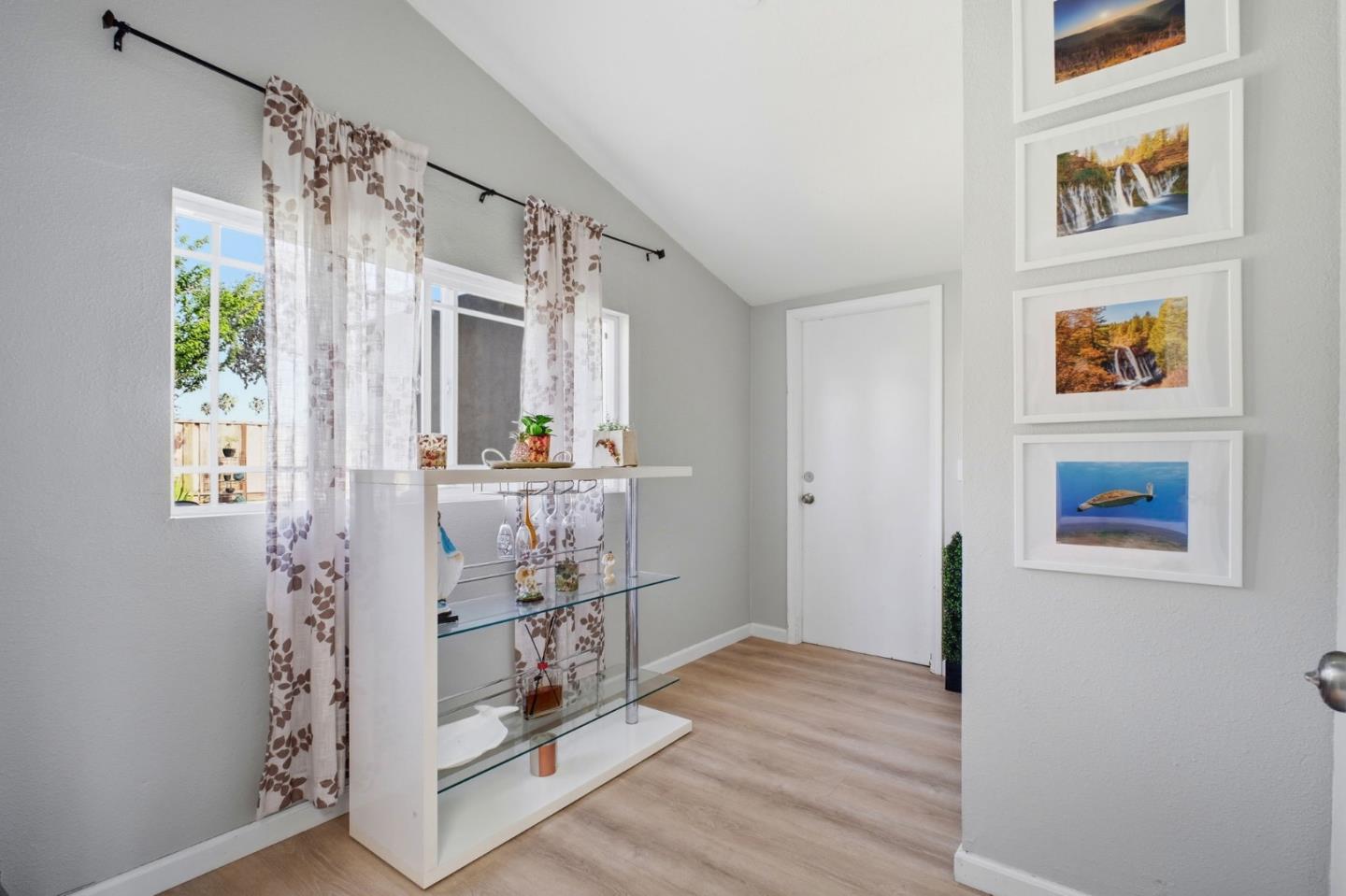 36985 Walnut Street Newark, CA 94560 - Photo 19 of 30 a view of a hallway with wooden floor and a living room