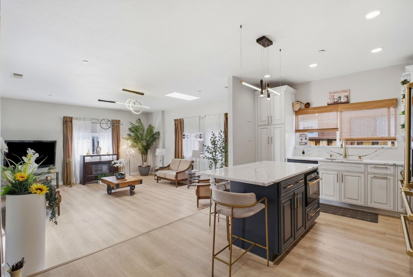 36985 Walnut Street Newark, CA 94560 - Photo 8 of 30 a open kitchen with stainless steel appliances kitchen island granite countertop a table chairs refrigerator and sink