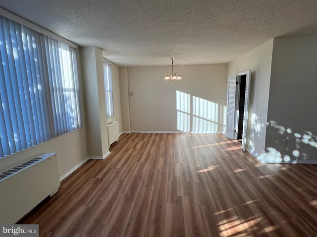 a view of a room with wooden floor and stairs