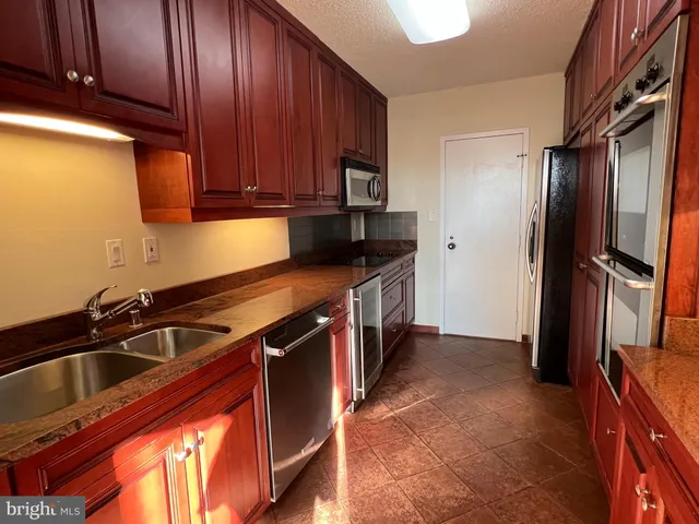 a kitchen with a sink stove and refrigerator