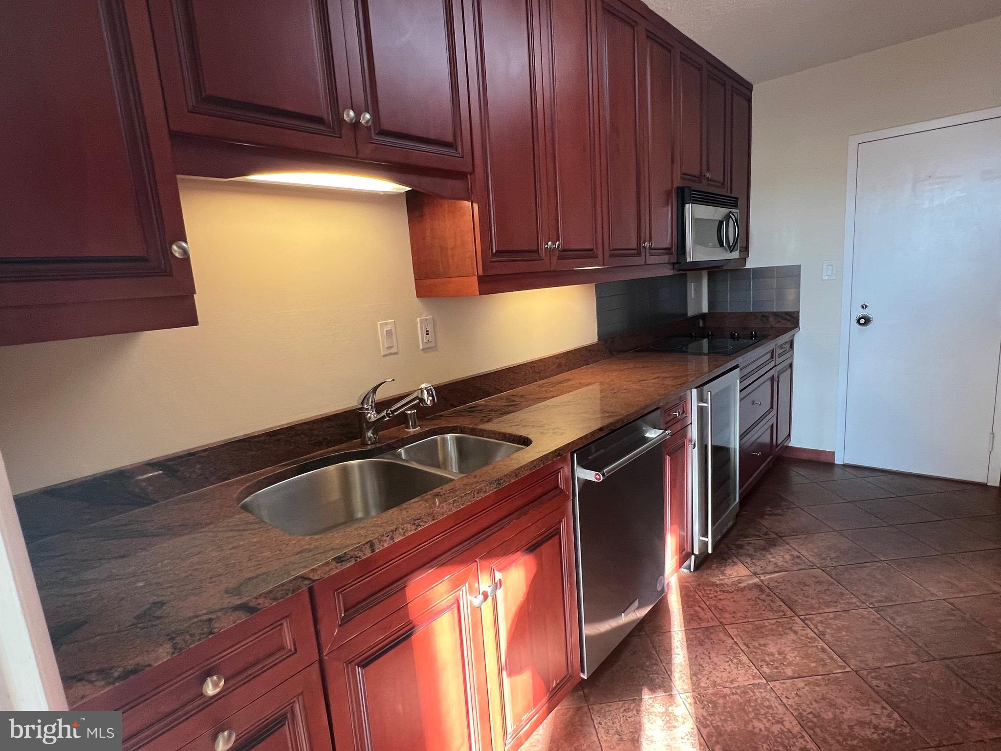 4401 Roland Avenue, Unit 402 Baltimore, MD 21210 - Photo 16 of 43 a kitchen with a sink and cabinets