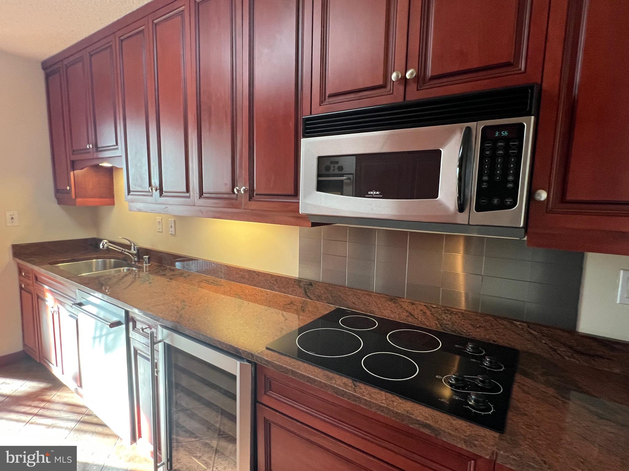 4401 Roland Avenue, Unit 402 Baltimore, MD 21210 - Photo 17 of 43 a kitchen with a stove and a microwave
