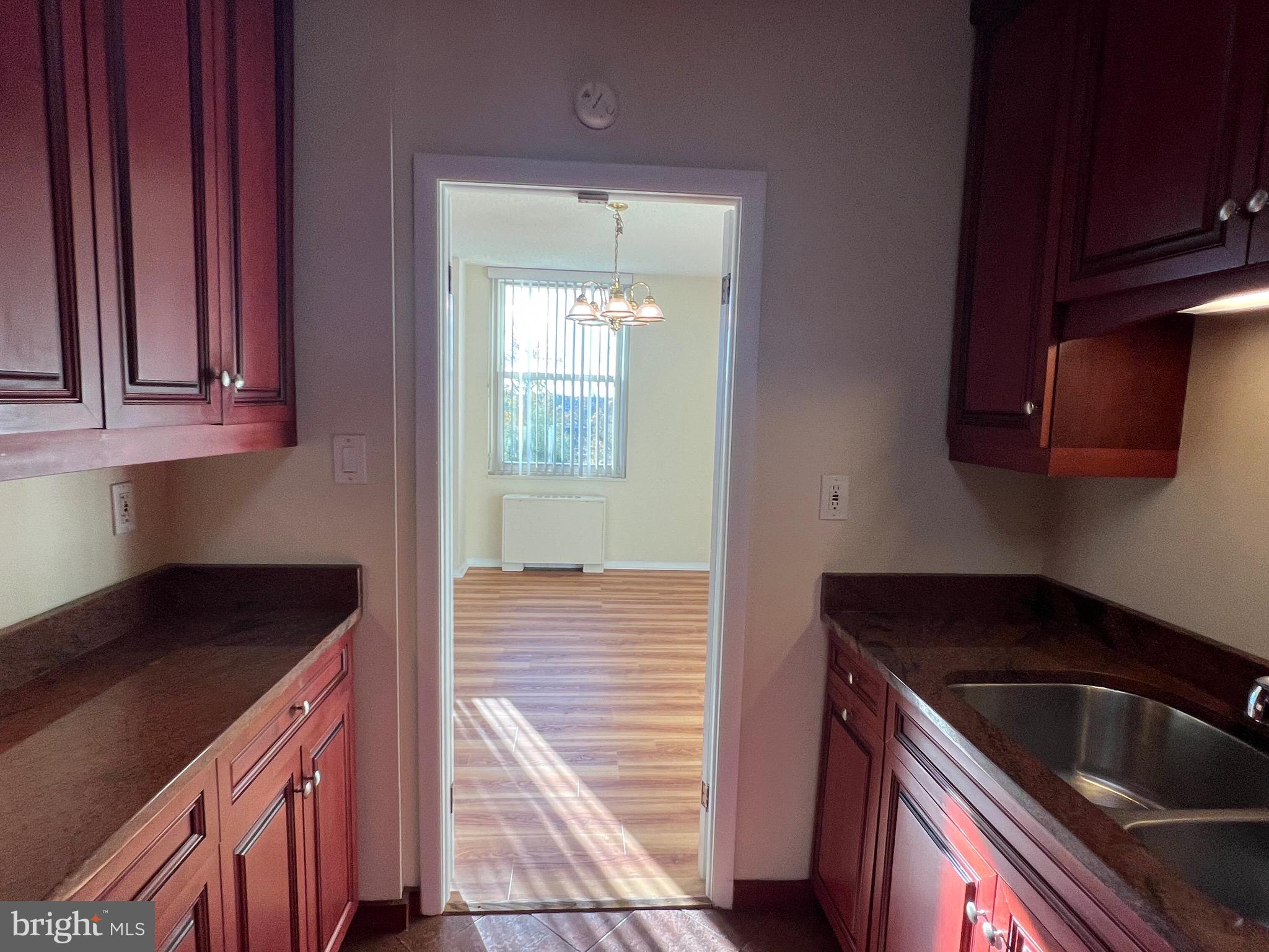 4401 Roland Avenue, Unit 402 Baltimore, MD 21210 - Photo 22 of 43 a kitchen with granite countertop a sink and cabinets