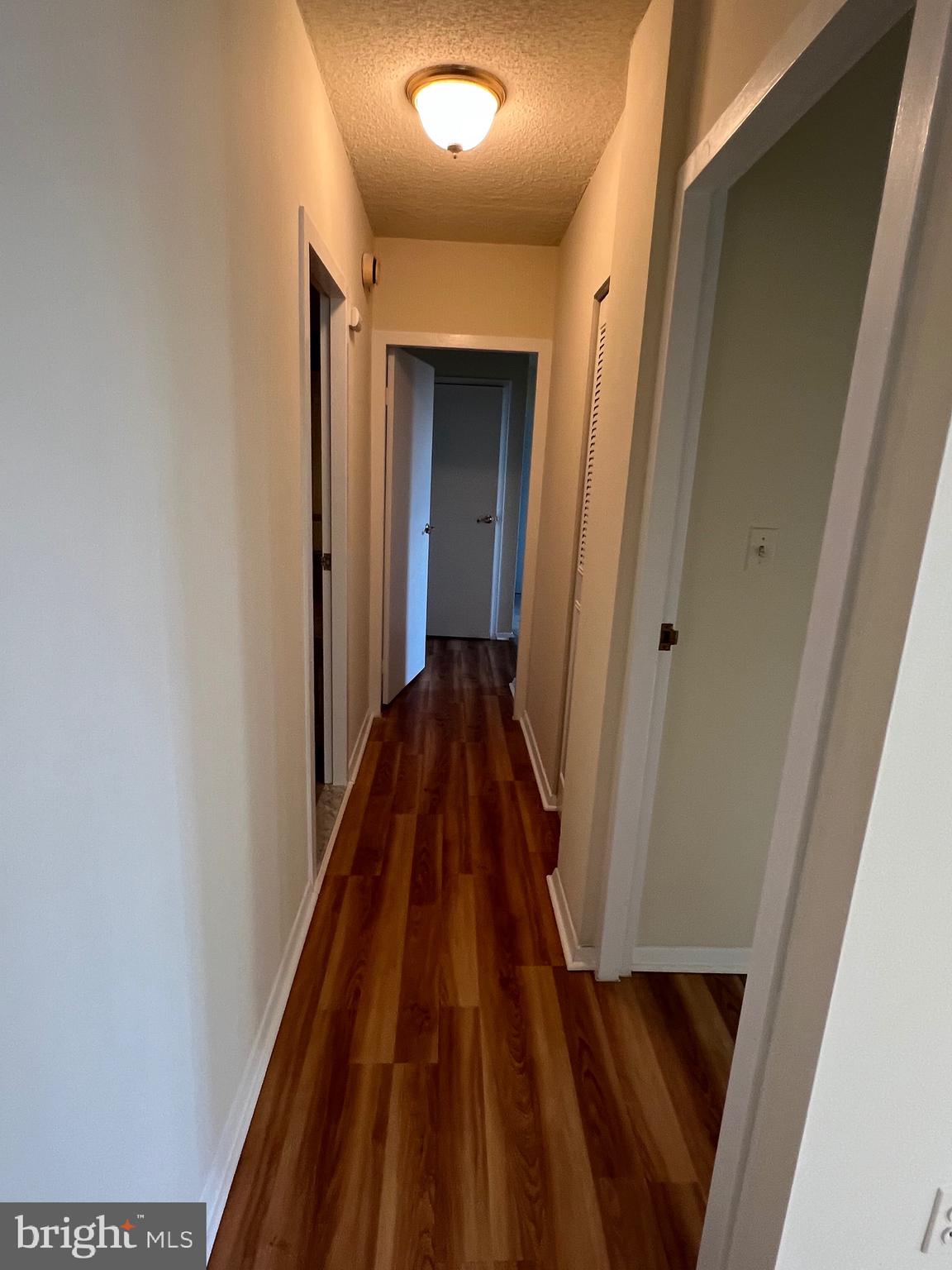 4401 Roland Avenue, Unit 402 Baltimore, MD 21210 - Photo 23 of 43 a view of a hallway with wooden floor and staircase