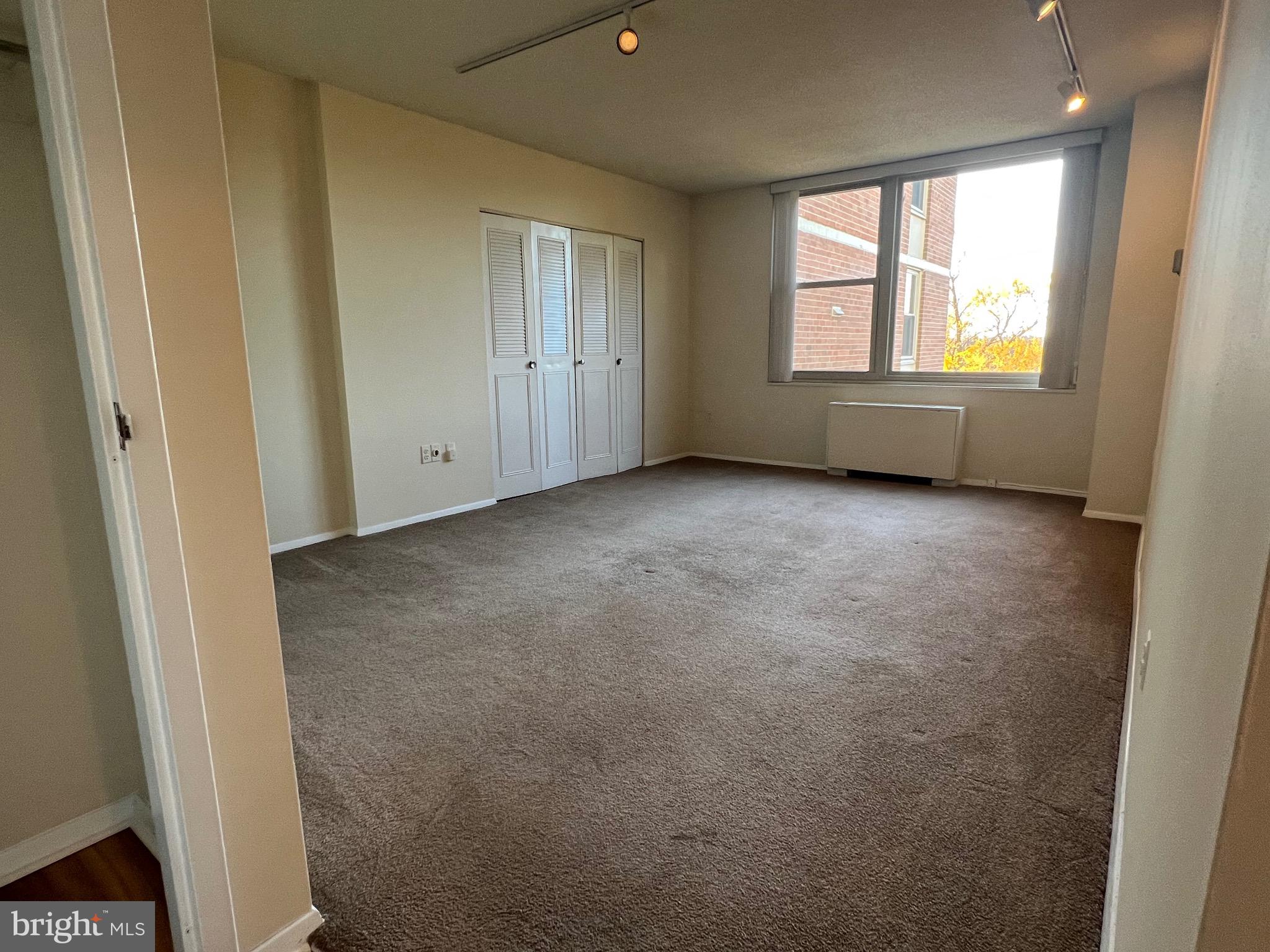 4401 Roland Avenue, Unit 402 Baltimore, MD 21210 - Photo 24 of 43 an empty room with windows and closet