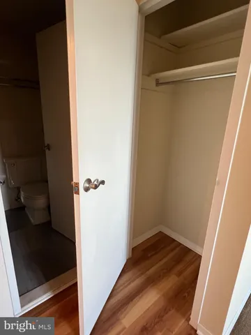 a view of walk in closet with empty room
