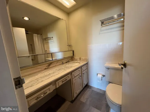 a white bath tub sitting next to a toilet