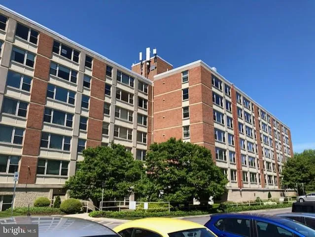 a front view of a building with street view and tall building