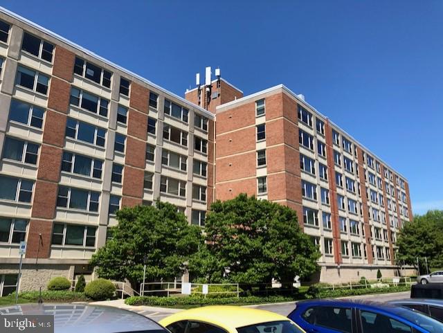 4401 Roland Avenue, Unit 402 Baltimore, MD 21210 - Photo 3 of 43 a front view of a building with street view and tall building
