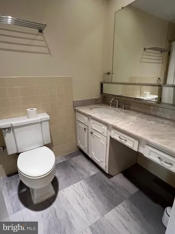 a bath tub sitting next to a white sink and a shower