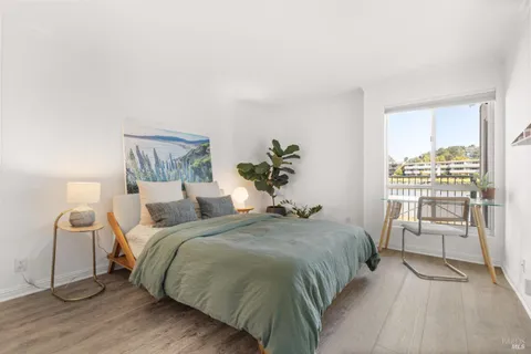 a bedroom with a bed and a chair