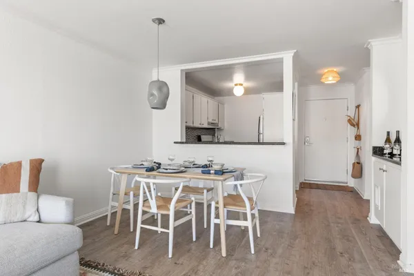 a kitchen with stainless steel appliances granite countertop a sink a stove and white cabinets