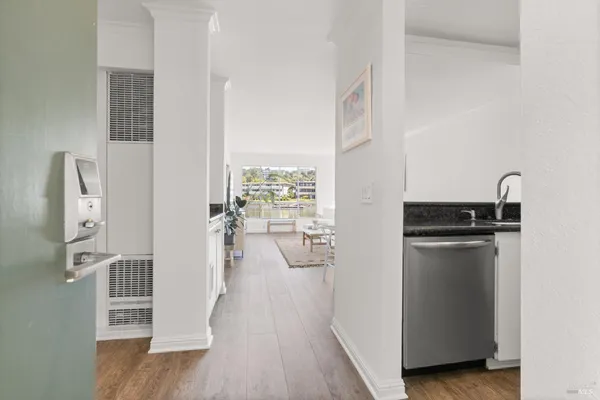 a kitchen with stainless steel appliances granite countertop white cabinets and a stove