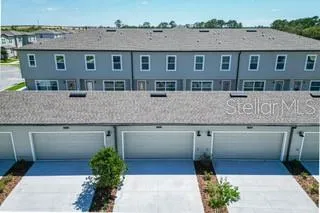 a front view of a house with a yard and lake view