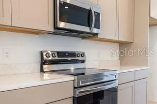 a kitchen with appliances cabinets and a microwave