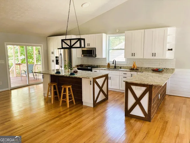 a room with lots of wooden furniture and a chandelier