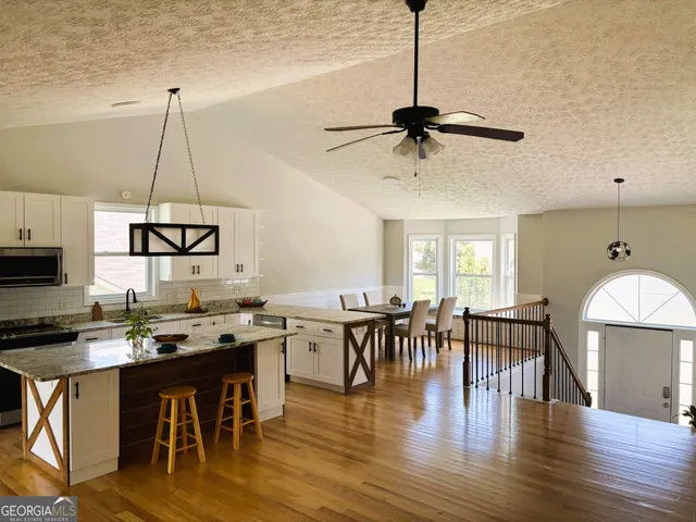 a kitchen with stainless steel appliances granite countertop wooden cabinets a sink and dishwasher