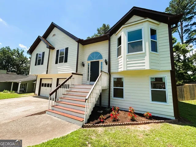 a front view of a house with a yard