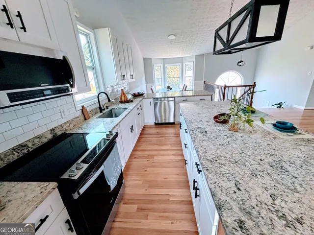 a kitchen with sink cabinets and stove