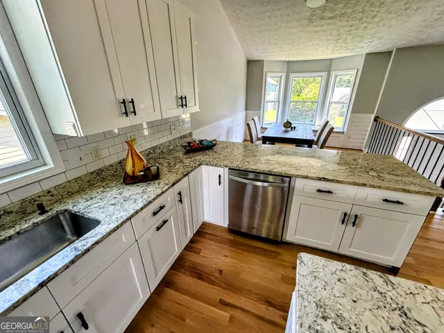 a bathroom with a sink toilet and mirror